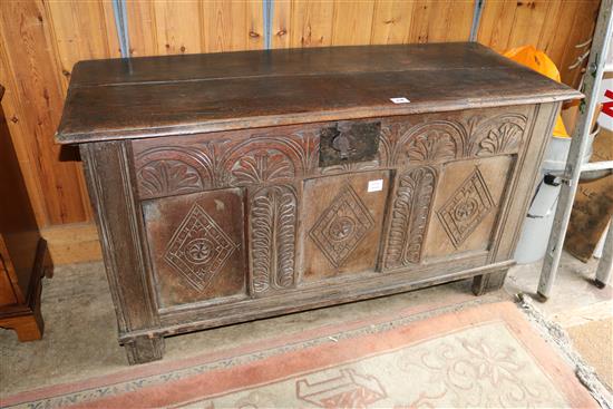 A carved oak triple panelled coffer(-)